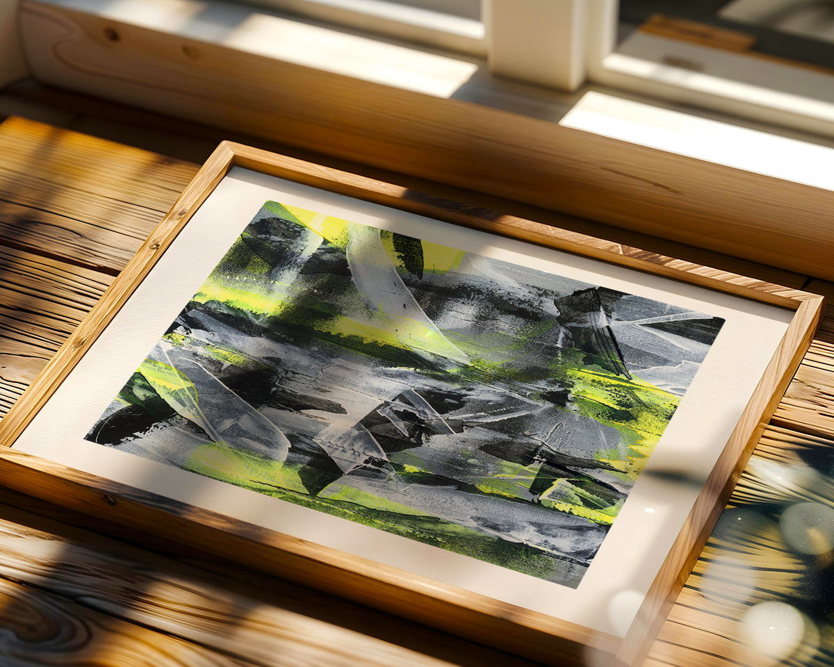 a yellow abstract original paper painting in a natural wood frame placed in front of a window on a sunny day