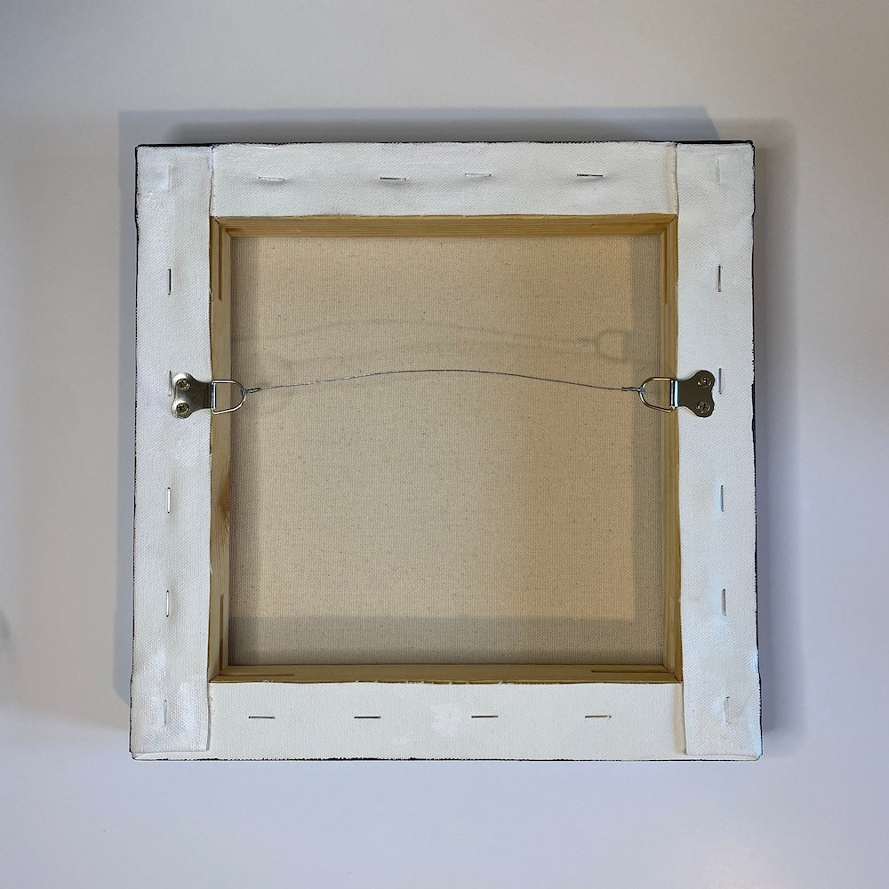 The back of a canvas showing the hanging hardware