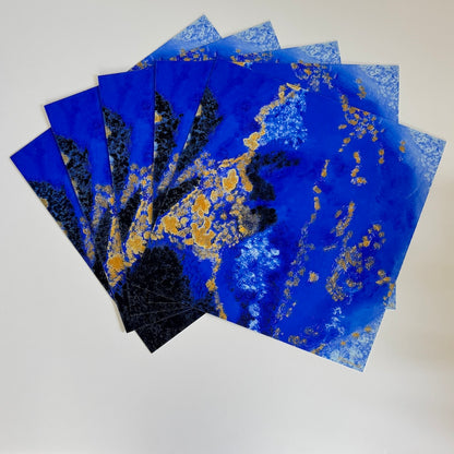 5 blue abstract limited edition paper prints fanned out on a white backdrop