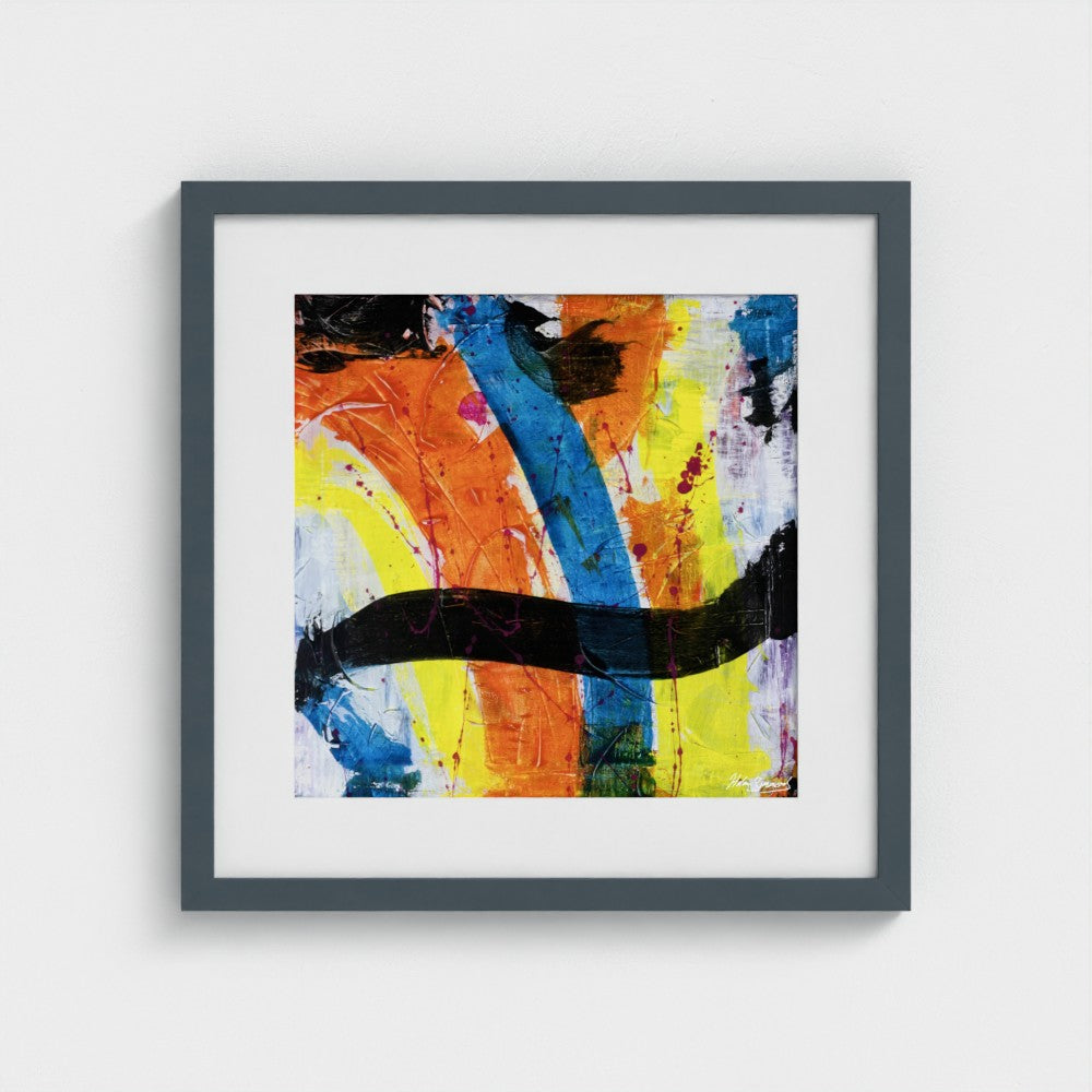 A colourful paper art print in a dark grey frame styled on a light wall