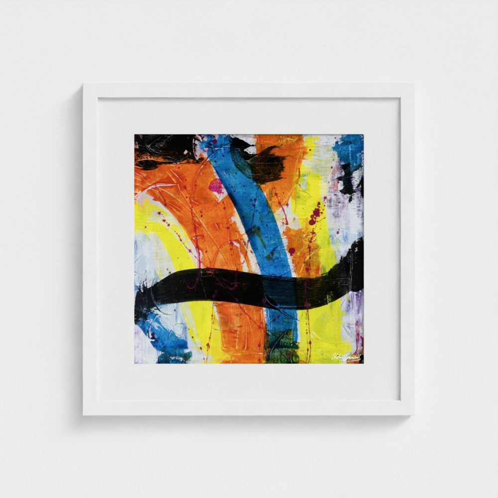 A colourful paper art print in a white frame styled on a light wall