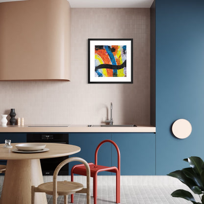 A colourful paper art print in a black frame styled on a light wall in a kitchen with blue cupboards.