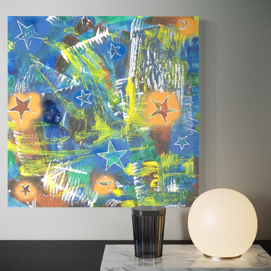 Abstract painting with stars on a wall above a table with a glass and lamp.