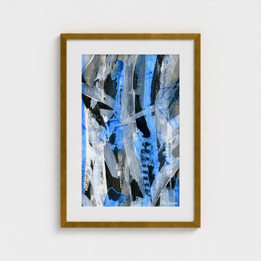 A blue abstract paper art print in an antique gold frame styled on a light wall