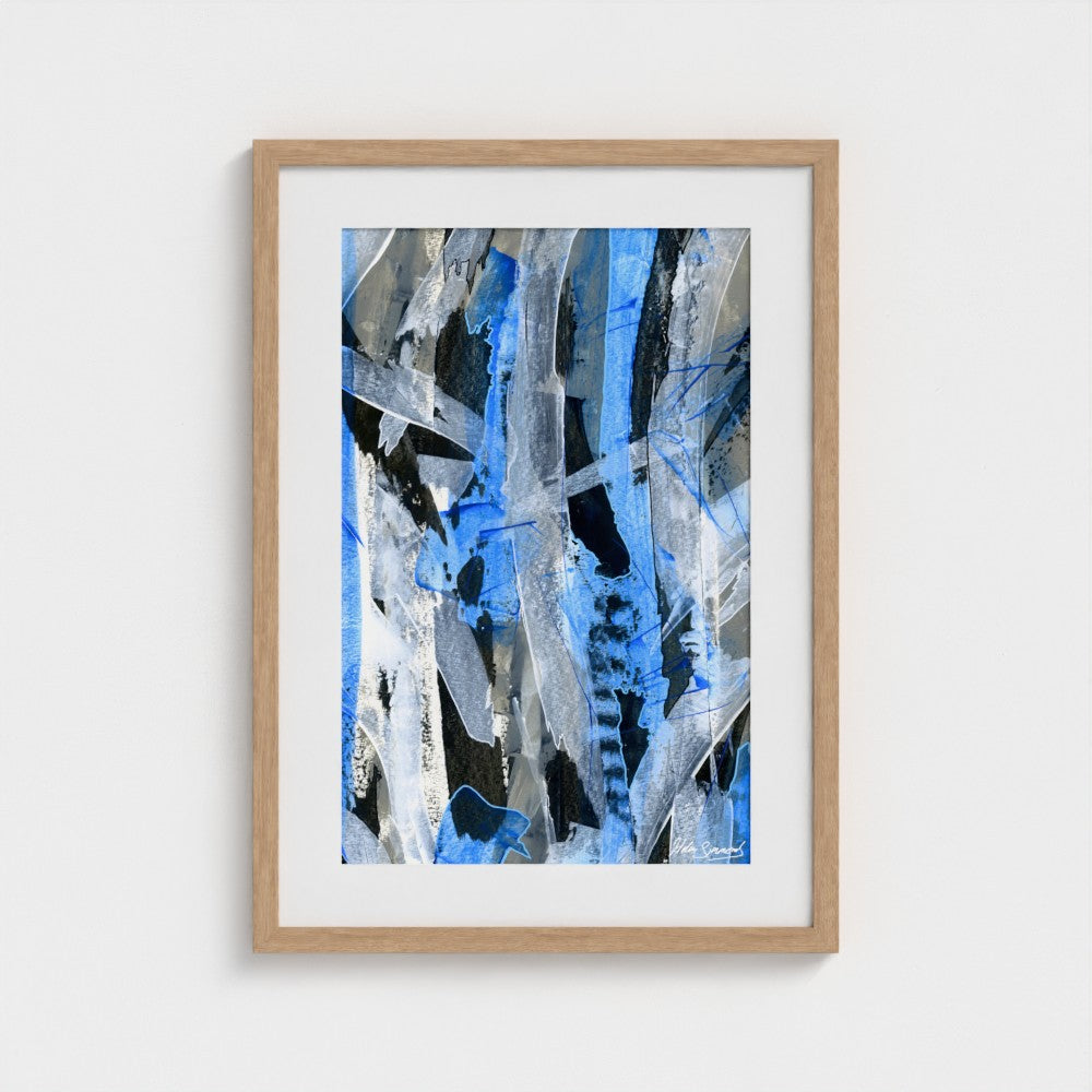 A blue abstract paper art print in a natural frame styled on a light wall