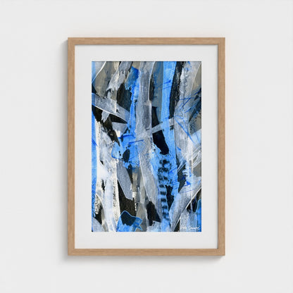 A blue abstract paper art print in a natural frame styled on a light wall