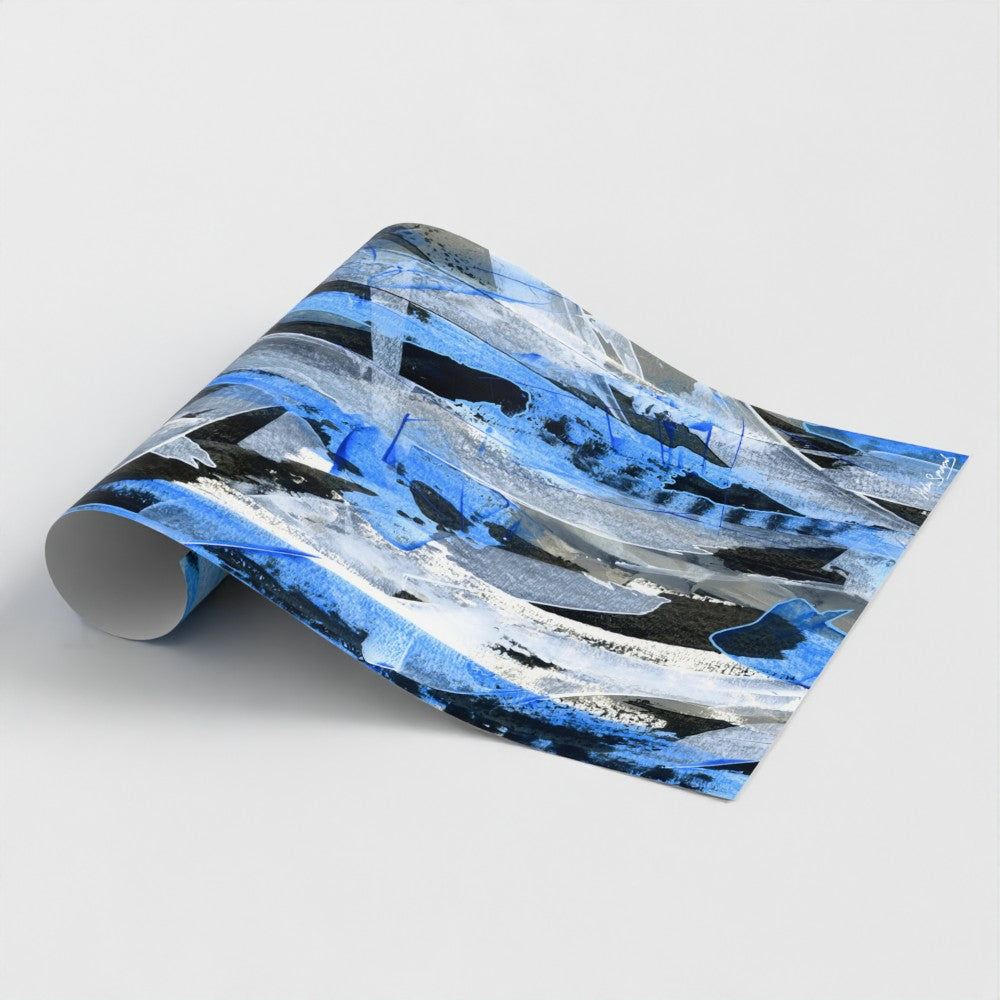 A rolled blue abstract paper art print styled on a light surface