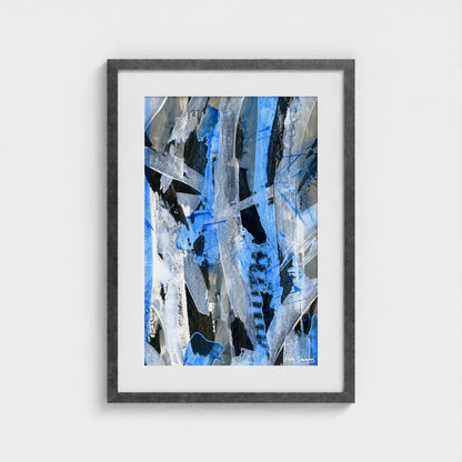 A blue abstract paper art print in an antique silver frame styled on a light wall