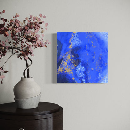 a blue abstract original canvas on a light wall next to  vase of flowers
