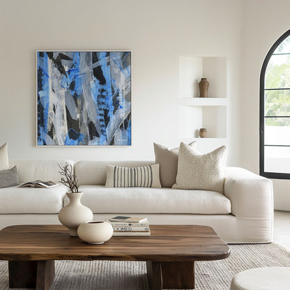 Square white framed blue abstract canvas wall art print in a light living room