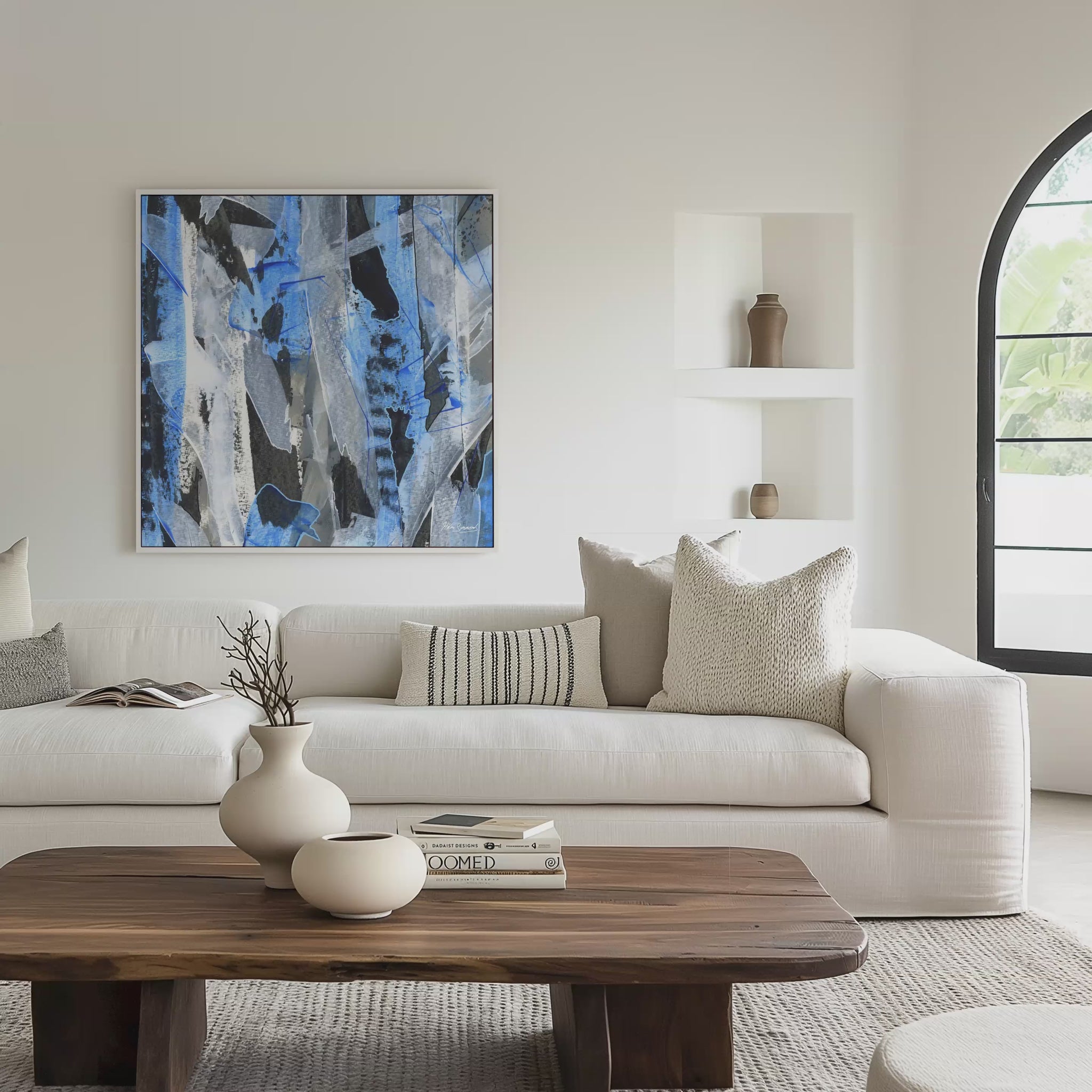 Square white framed blue abstract canvas wall art print in a living room, video mockup